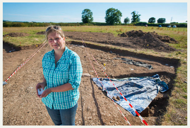 Danielle Wootton at Ipplepen excavation holding a newly found Roman brooch