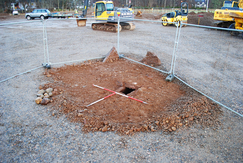 They did not expect that! - BUt the cist burial is fenced off, excavated and the construction carries on around the archaeology.  