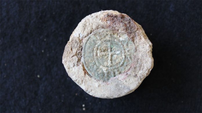 Coin set into weight. Image: Archaeological Solutions Ltd