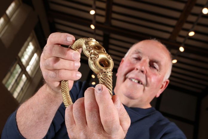 Maurice Richardson holding the Iron Age Torc he discovered in 2005 which has gone on public display just four miles from where it was found. Credit National Civil War Centre/Doug Jackson