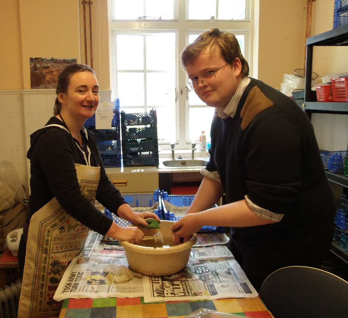 Volunteers clean the pottery from Thaxted. Image: CAT