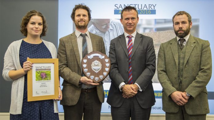 Wessex Archaeology’s Jackie McKinley, Phil Andrews and Dave Murdie collect their award from Defence Minister Mark Lancaster Photo: Ministry of Defence