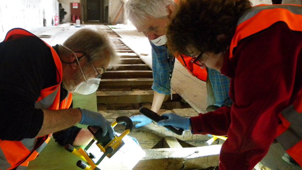 Archaeology volunteers investigate under the floorboards (c) National Trust