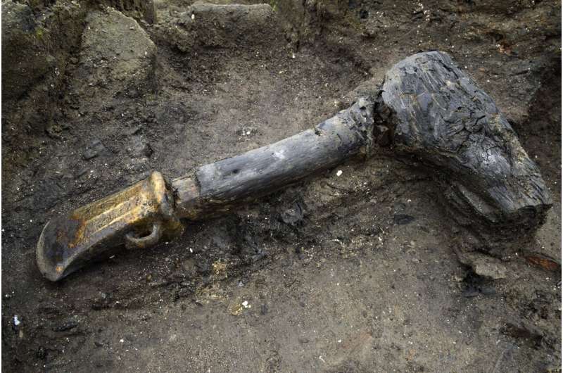 An intact hafted axe that had been placed in the silt directly beneath Structure One, perhaps a token of good luck.   Credit: Cambridge Archaeological Unit 